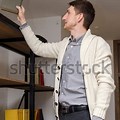 Person Putting Books On Shelf