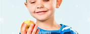 Child Eating Apple On Blue Striped T-Shirt