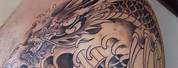 Dragon Wrapped around a Cross Tattoo