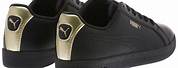 Puma Black and Gold Sneakers