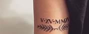 Roman Numerals Tattoo above Elbow