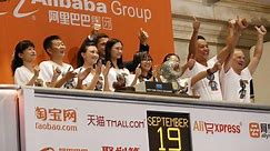 MoneyWatch: Alibaba makes history; iPhone fans get surprise greeting