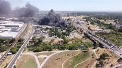 209 Times - Drone footage of junkyard fire near John...