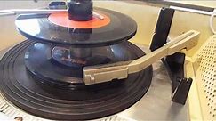 Silvertone record player playing a stack of 45 RPM records.