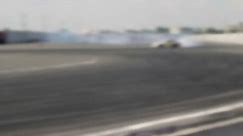Drift car racing on the asphalt track. A lot of smoke. Blur.