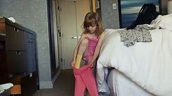 Little Girl Putting on Pink Pants