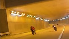 Bikers Race Through Freeway Tunnel