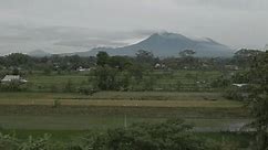 morning views of volcanoes and green rice fields