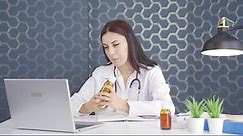 Premium stock video - Woman doctor describing medicine on facetime.