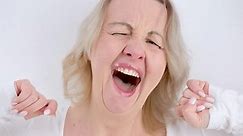 Funny sleepy yawning Asian woman just wake up on bed. Yawning Tired woman on White Background