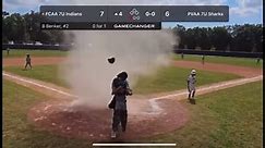 Umpire shields child from dust devil during youth baseball game