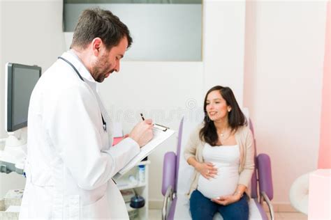Female Patient Talking About Her Pregnancy With Her Doctor Stock Image