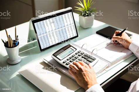 businessman calculating invoice  calculator stock photo