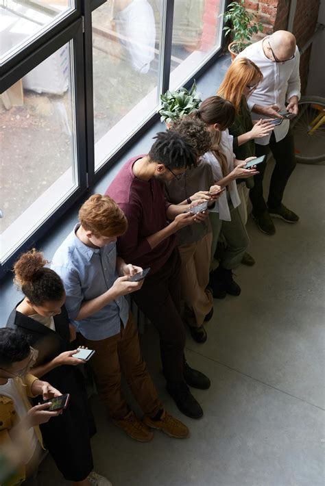 people holding  phones  stock photo
