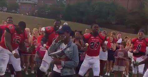 Football Player Proposes On Field With Teammates