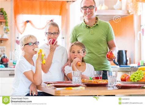 father and daughters in kitchen eating healthy royalty free stock images image 34333619