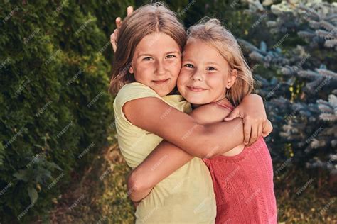 Free Photo Close Up Portrait Of Two Happy Girlfriends Cuddling In The