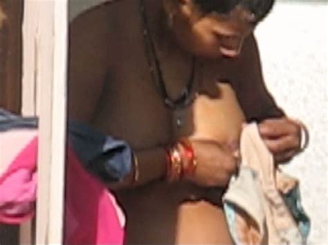 amateur busty indian lady in open air washing herself