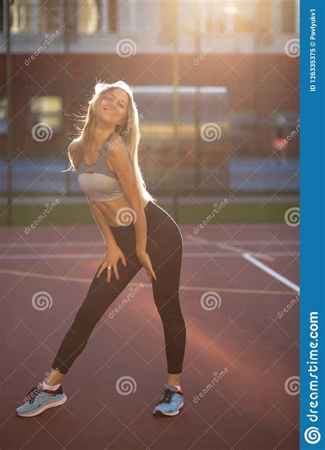 Happy Fitness Model With Beautiful Smile Posing On A
