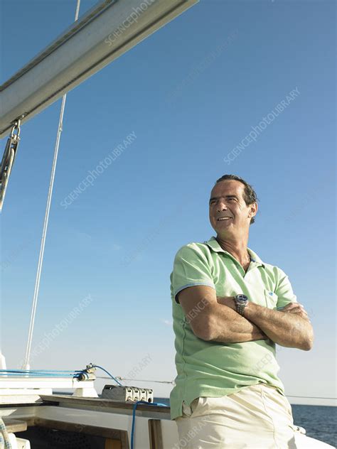 Mature Man Standing On Yacht Smiling Stock Image F003 2472