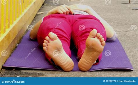 the girl lies on her back and wiggles her feet stock footage video