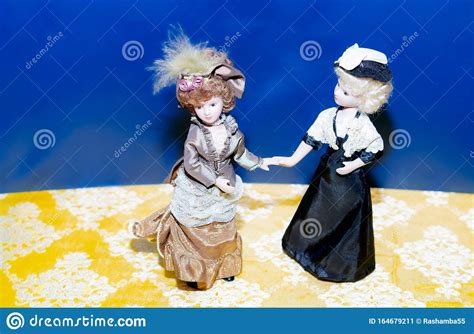 Ceramic Porcelain Dolls In Vintage Dress Dolls Standing On The Blue