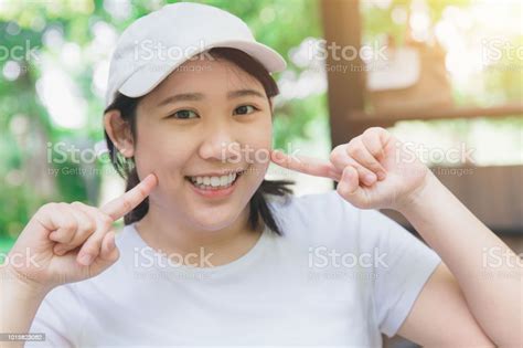 Asian Cute Teen Good Dental Health Smiling Finger At Her Cheeks Stock