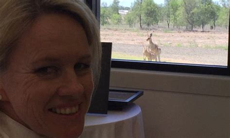 fiona nash takes selfie in front of two kangaroos having