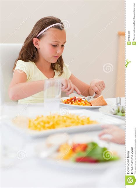 girl eating at dinner table stock images image 22440434