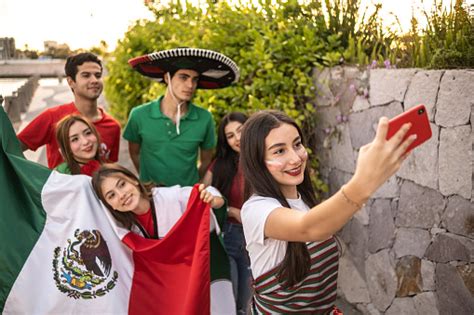 teenager latin friends taking selfies celebrating the mexican soccer