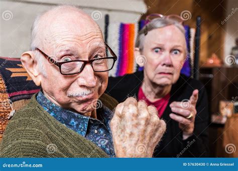 grandfather in tough guys pose with granddaughter stock image