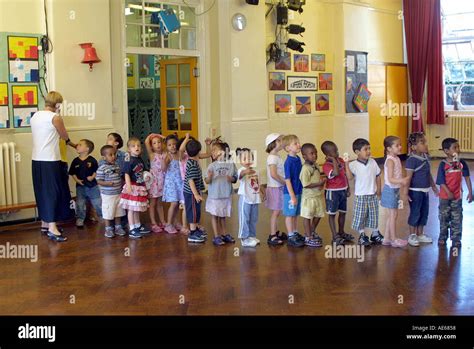 nursery children lining   school hall stock photo alamy