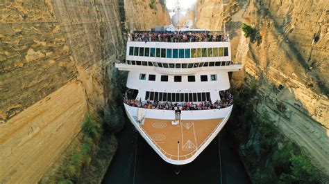 cruise ship passes  greek canal   feet  breathing room