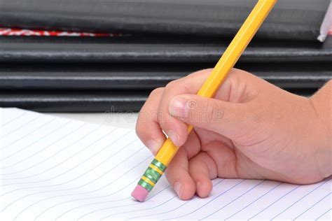 child  hand erasing  pencil  notebook paper stock photo image