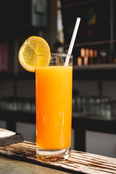 orange juice  clear drinking glass photo  drink image  unsplash
