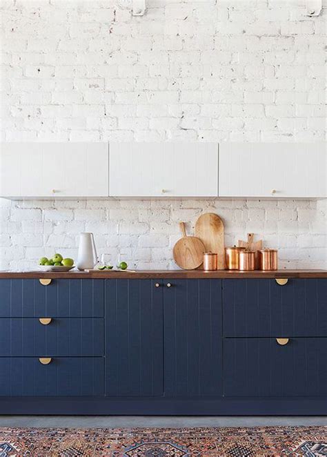white navy blue warm wood gold hardware copper accessories navy kitchen cabinets