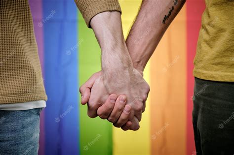 Premium Photo Gay Couple Holding Hands When Standing Against Lgbt