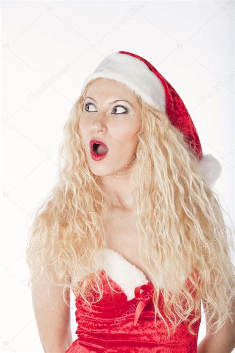 sexy girl with blonde curly hair dressed as santa having fun on