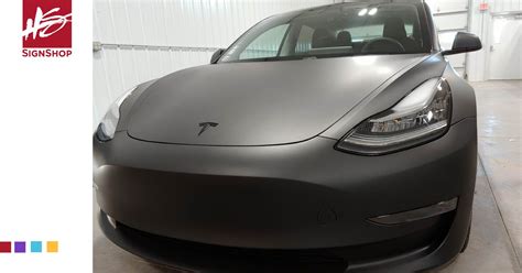 matte black car wrap transforms tesla hs sign shop