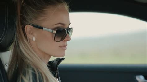 gorgeous blonde in sunglasses corrects stock footage video 100