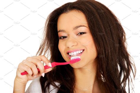beautiful teen brushing her teeth high quality people