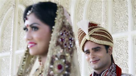 shot of indian bride and groom in traditional wedding dress posing