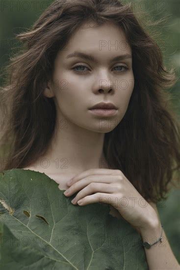 Caucasian Woman Covering Chest With Leaf Photo12 Tetra Images Ivan Ozerov