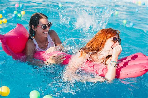 Girls Having Fun In The Swimming Pool By Lumina Stocksy