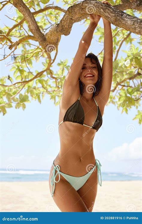 beautiful girlâ€™s in stylish bikini portrait posing on sandy beach in