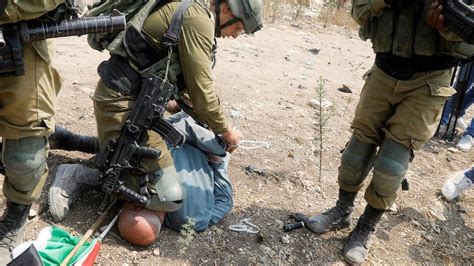 israeli soldier condemned for putting knee on palestinian protester s