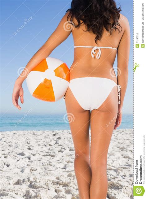 Back Of Womans Perfect Body Holding Beach Ball Stock