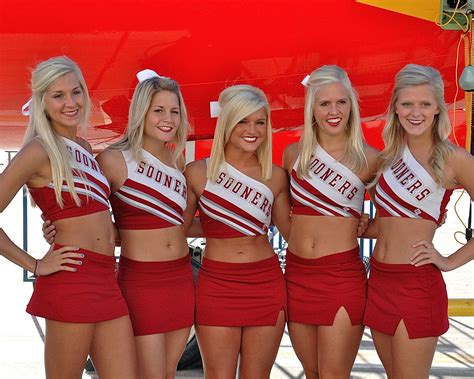 texas and oklahoma cheerleaders support fans as they pull an 83 000