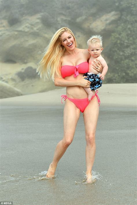 heidi montag shows off gym honed figure wearing a vibrant pink bikini on the beach with son
