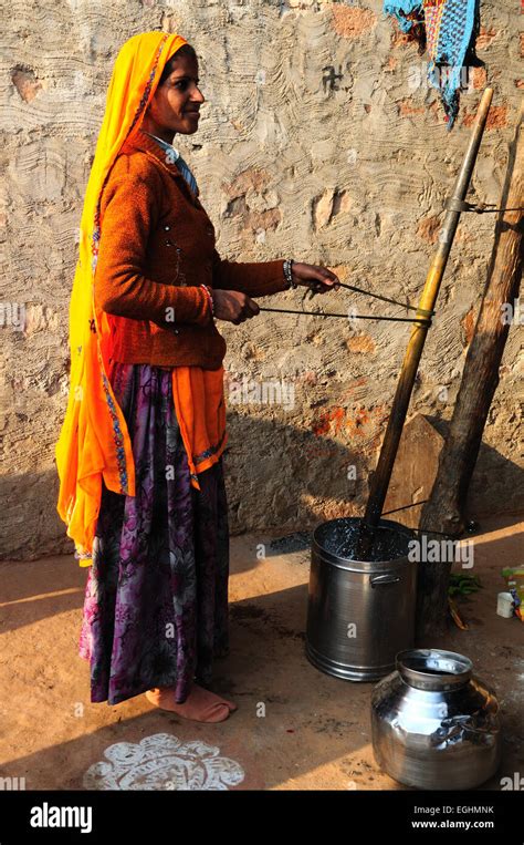 Indian Woman Churning Butter In Her Tribal Village Madhya Pradesh India